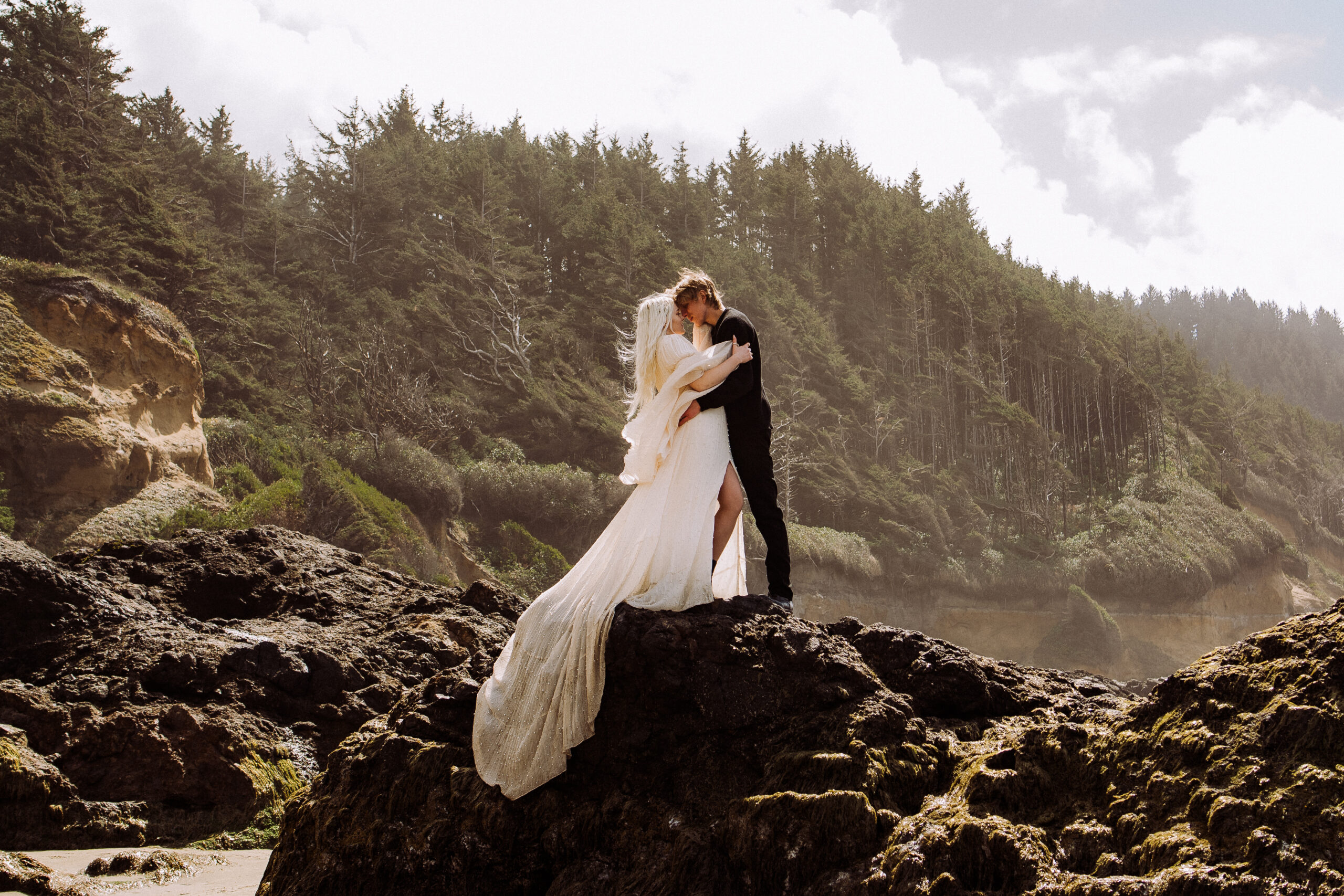 bride and groom standing on rock, beach, for destination wedding, elopement