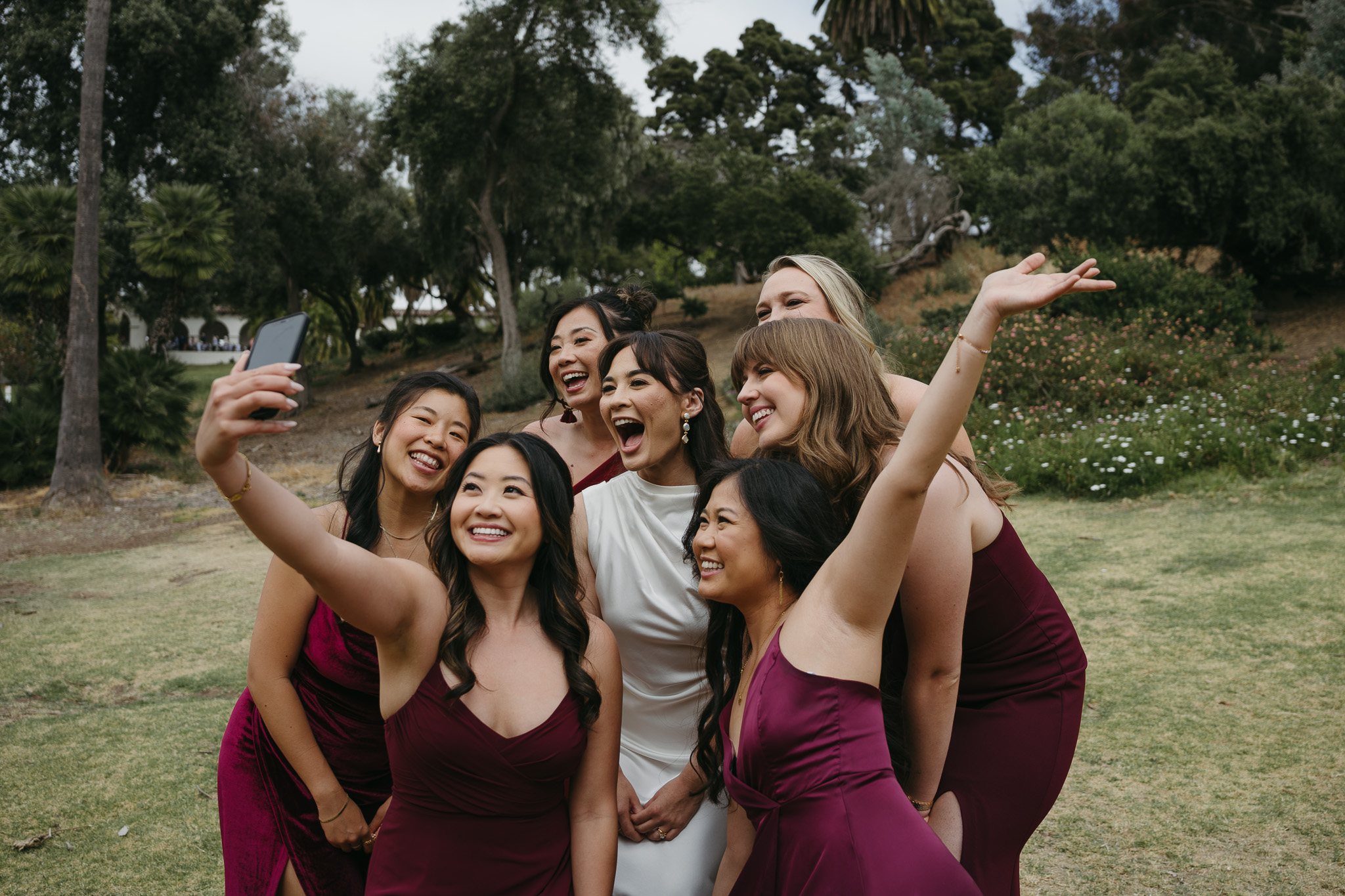 bride and bridesmaids taking a selfie on destination wedding day