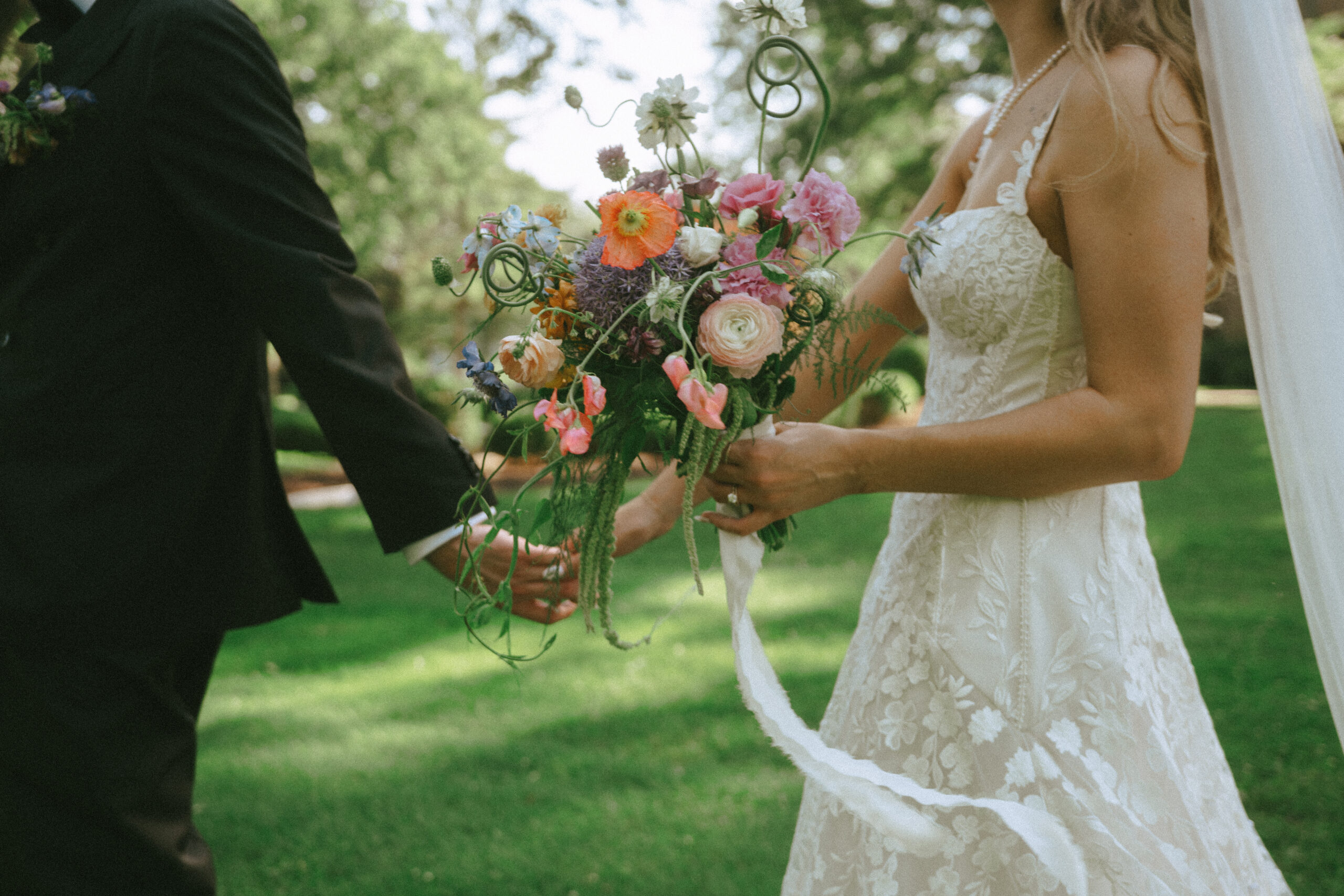 bride and groom holding hands, carrying bouquet at destination wedding